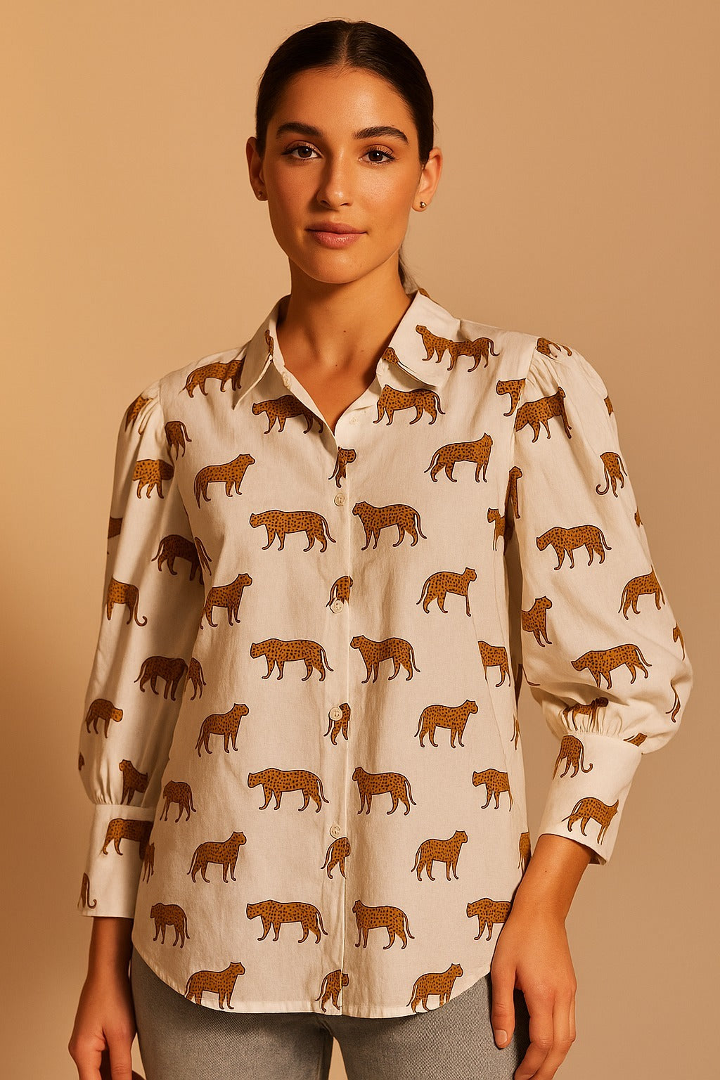Woman wearing a beige blouse with brown animal pattern on a beige background
