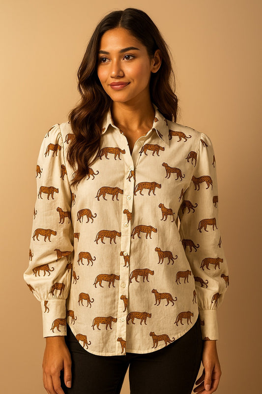 Woman wearing a beige shirt with animal pattern against a beige background
